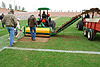 Crew on the field emoving sod after the AIA Championship games